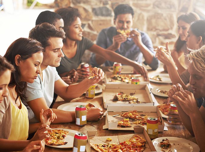 group of people enjoying a meal from Kelowna pizza restaurant Bless'd Sips & Slices